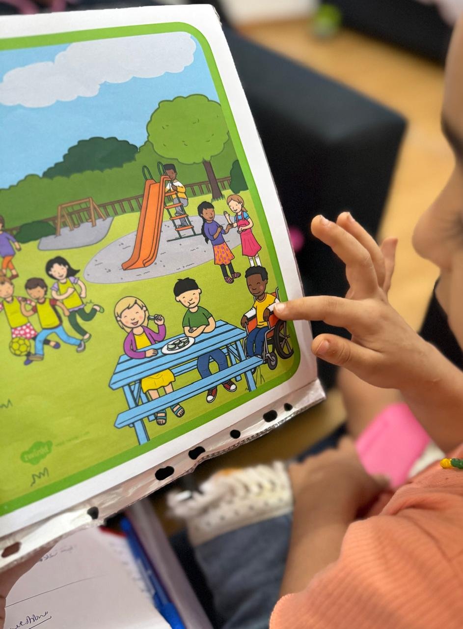 Child pointing to an illustrated scene