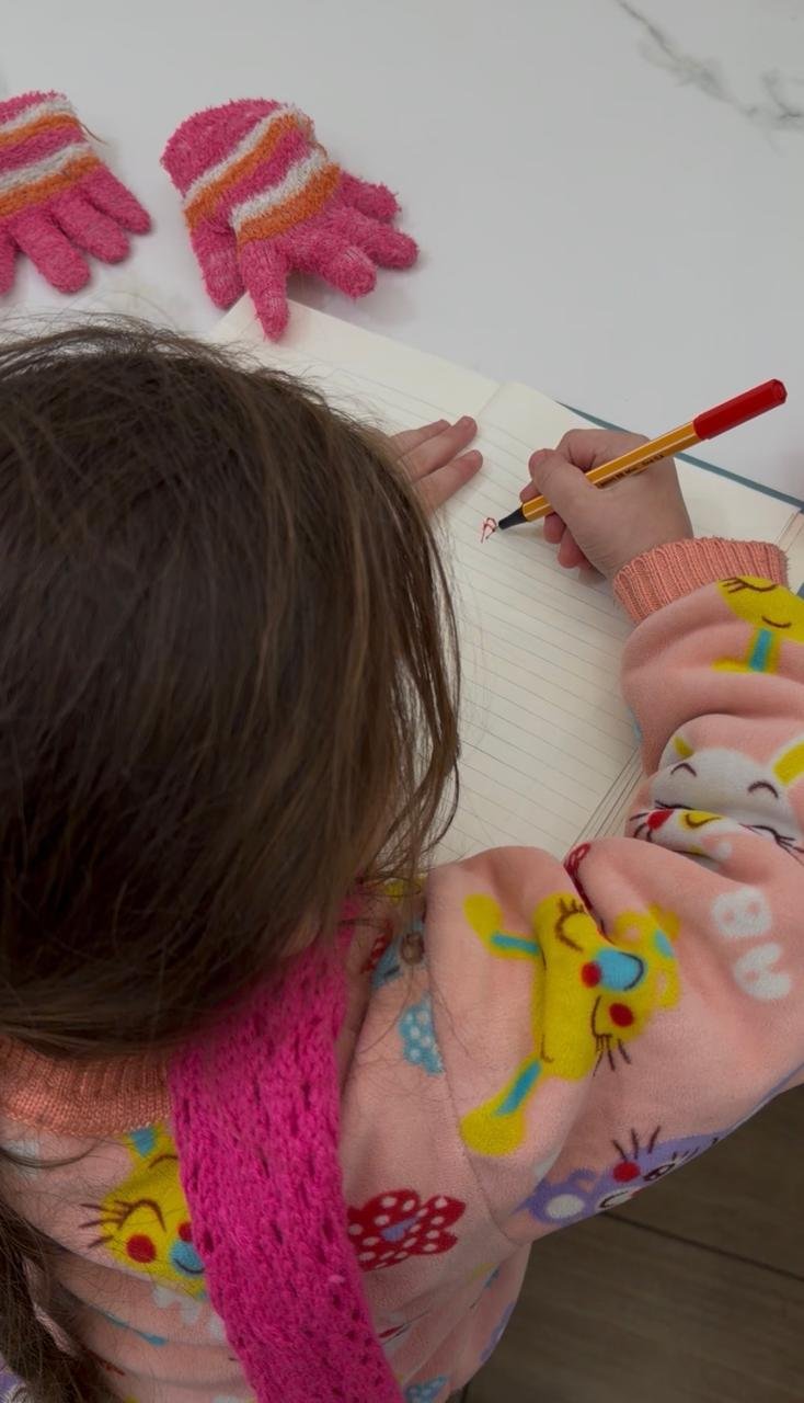 Child writing in a notebook